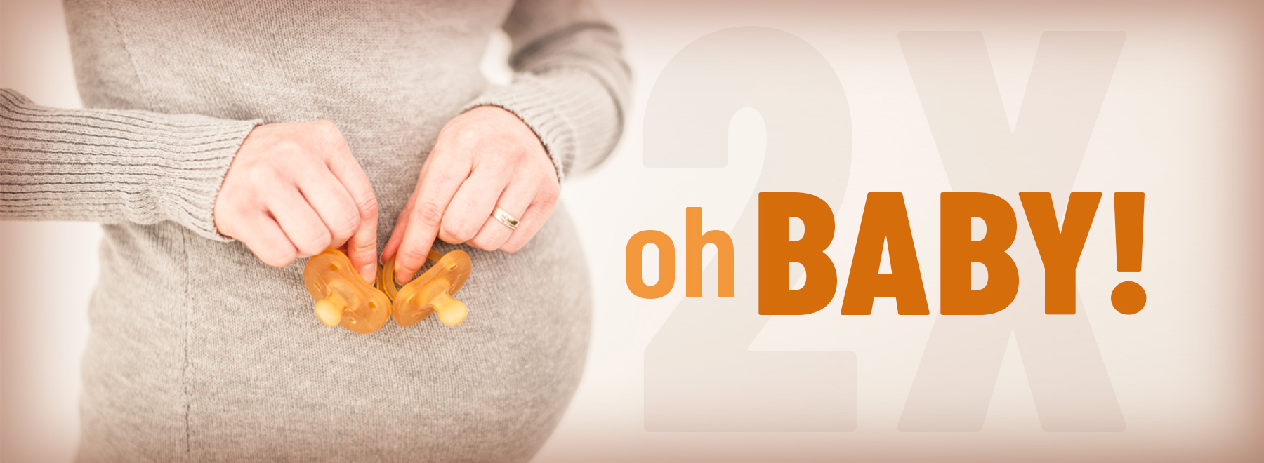 Photo illustration of a pregnant belly and the hands are holding two pacifers